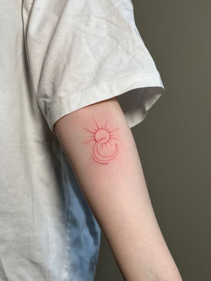 a person with a red tattoo on their arm