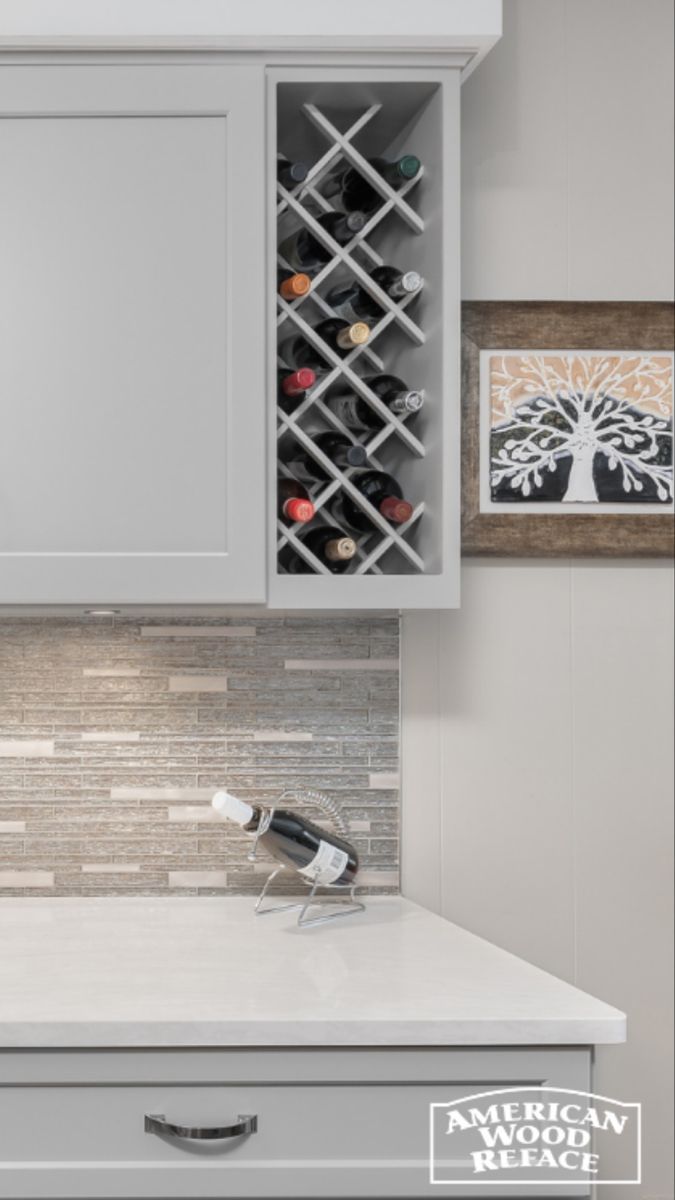 the wine rack is built into the wall above the kitchen countertop and below the cabinets