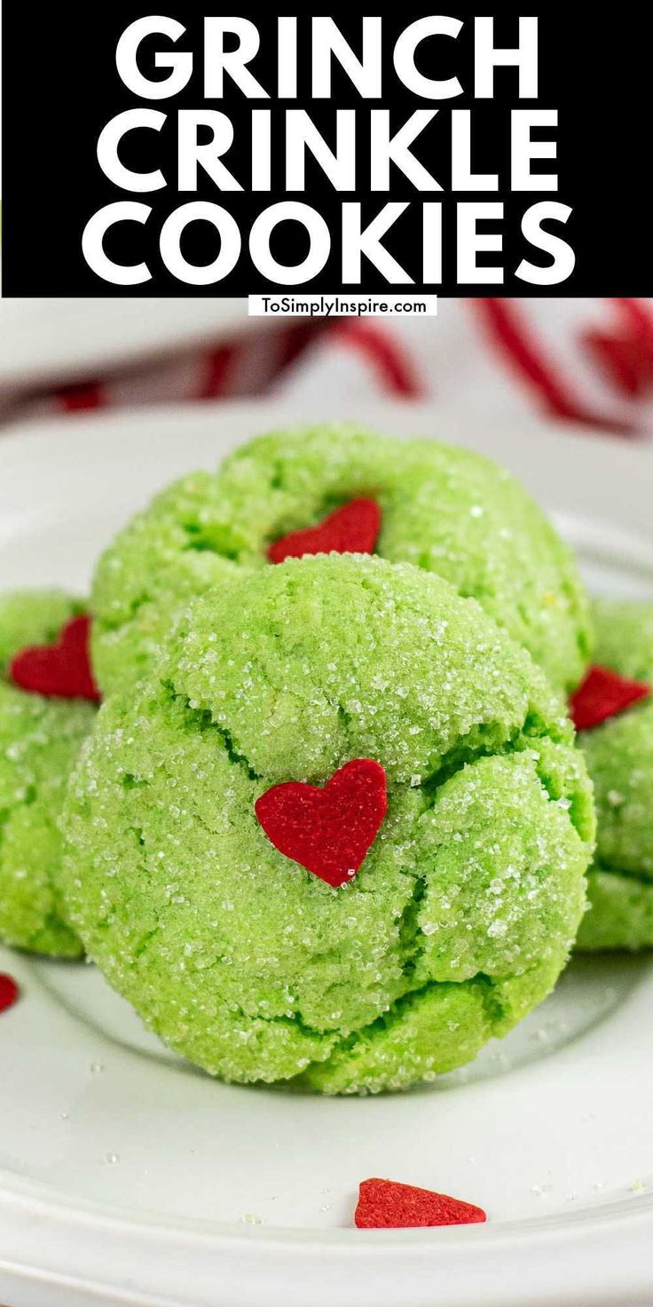 green cookies with red hearts on a white plate