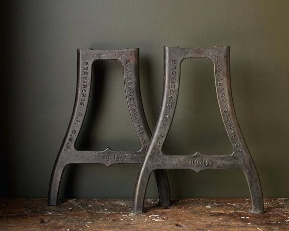 two metal chairs sitting on top of a wooden table