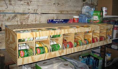 a wooden shelf filled with cans and other items