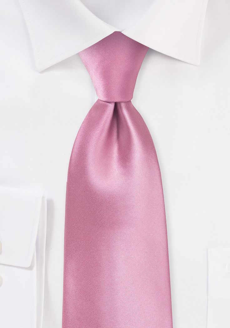 This carnation-pink tie with a subtle wash is the ideal accessory for a day full of sunshine. This is a very fashionable option for bridesmaids and groomsmen to wear to weddings in the spring and summer because of the outstanding shine and the pink color. Yet, if you are seeking a contemporary summer ensemble, this tie is equally as well suited for work clothing as it is for casual wear. To complement this tie, we advise opting for a suit in a light or medium grey shade and a traditional white d Classic Pink Suit And Tie Accessories For Summer, Classic Pink Tie Accessories For Summer, Elegant Pink Standard Tie, Classic Summer Wedding Suit And Tie Accessories, Elegant Pink Ties For Black Tie Occasions, Classic Pink Tie For Black Tie Events, Elegant Pink Standard Tie And Accessories, Elegant Pink Standard Tie Suit Accessories, Classic Suit And Tie Accessories For Spring Wedding