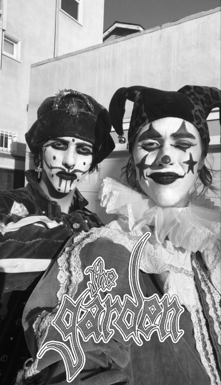 two clowns are posing for a black and white photo