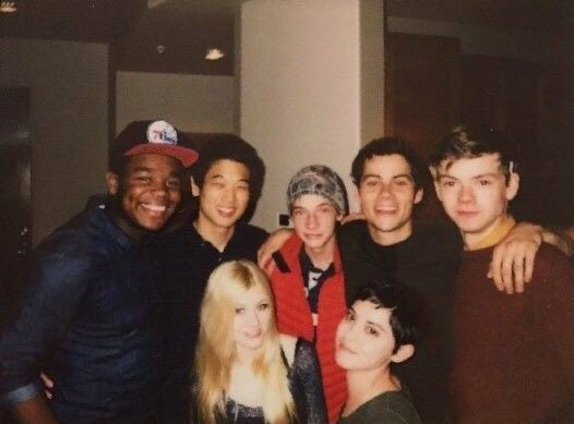 a group of young men and women posing for a photo