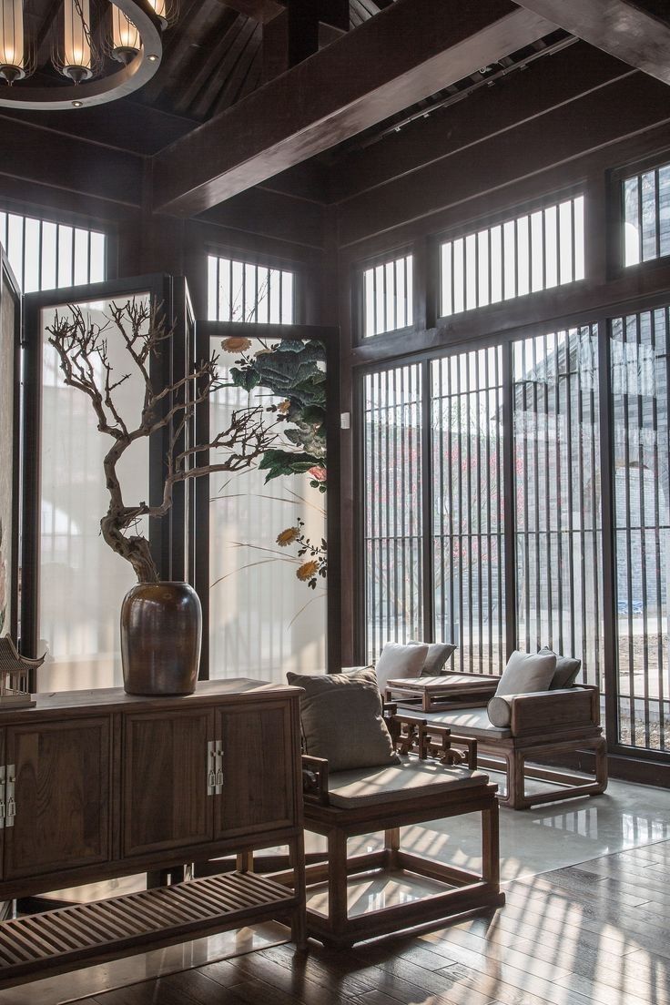 a living room filled with furniture and large windows