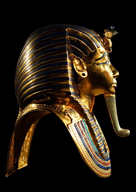 an egyptian mask is shown against a black background