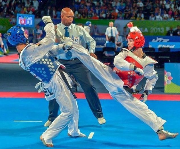 two men are in the middle of a wrestling match