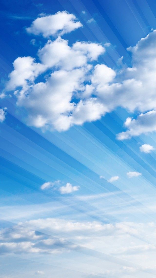 an airplane flying in the blue sky with white clouds and sunbeams above it