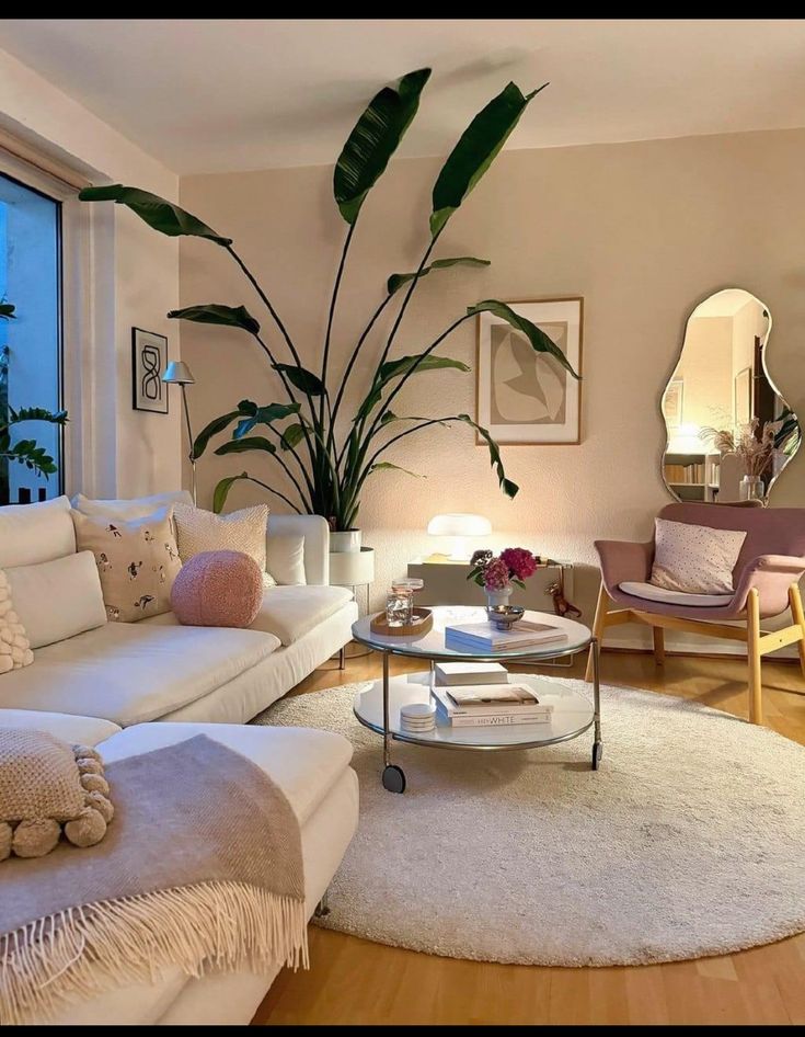 a living room filled with furniture and a large plant in the middle of the room