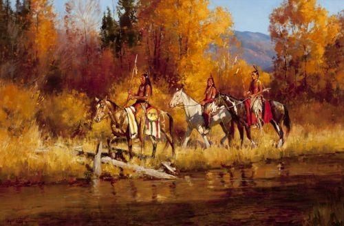 three people riding horses across a river surrounded by trees in the fall time with yellow foliage