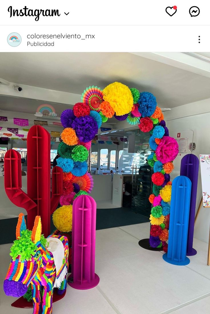 colorful paper flowers decorate the entrance to an art gallery for children's birthdays