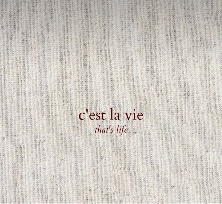 the words cest la vie that's life written in red ink on white linen