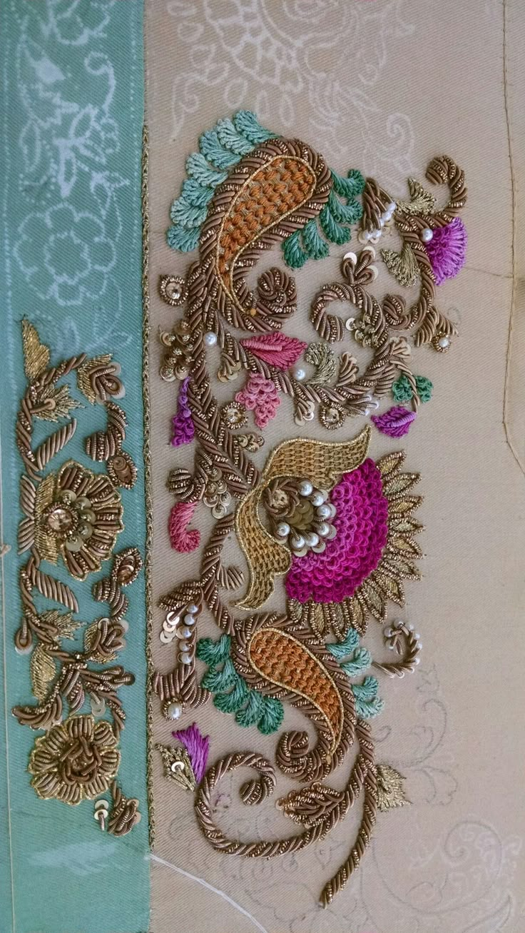 an intricately designed piece of cloth with gold and pink beads on it's side