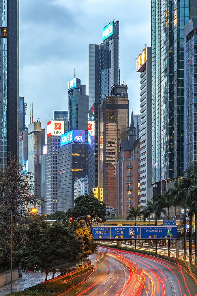 the city skyline is lit up with bright lights and skyscrapers in the back ground