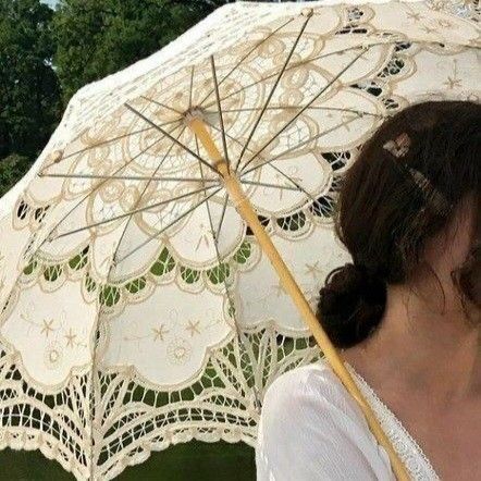 a woman holding an umbrella in her hand