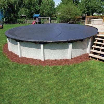 an above ground pool surrounded by grass