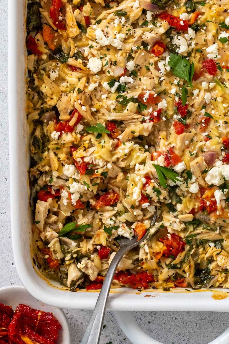 a casserole dish with chicken, spinach and feta cheese