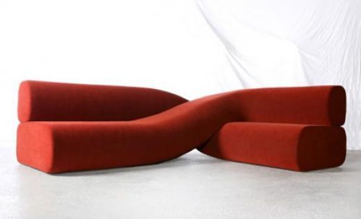 a red couch sitting on top of a white floor