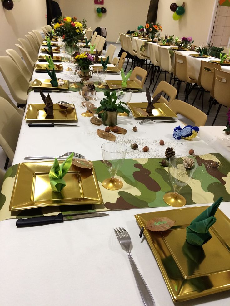 a long table with place settings and flowers on it