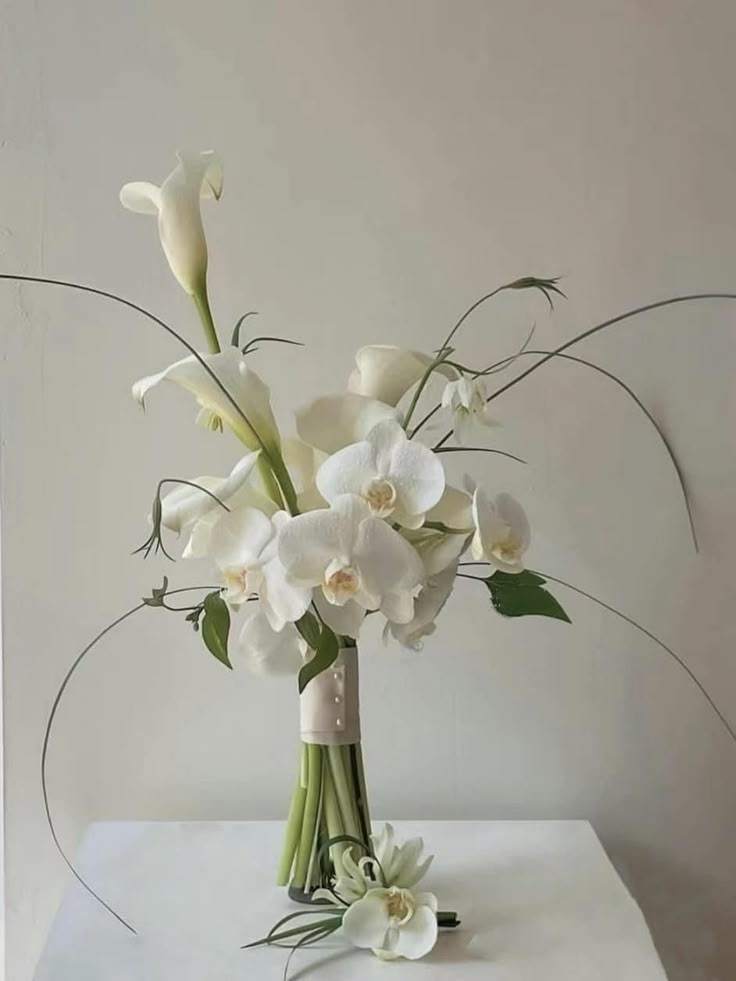 a vase filled with white flowers on top of a table