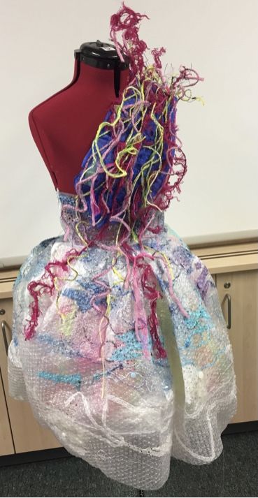 a dress made out of plastic and yarn