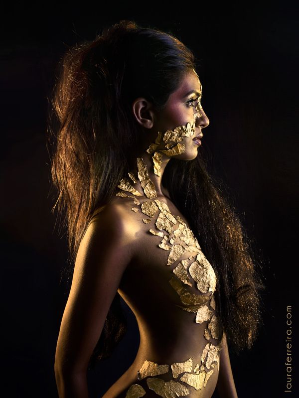 a woman with gold paint on her body