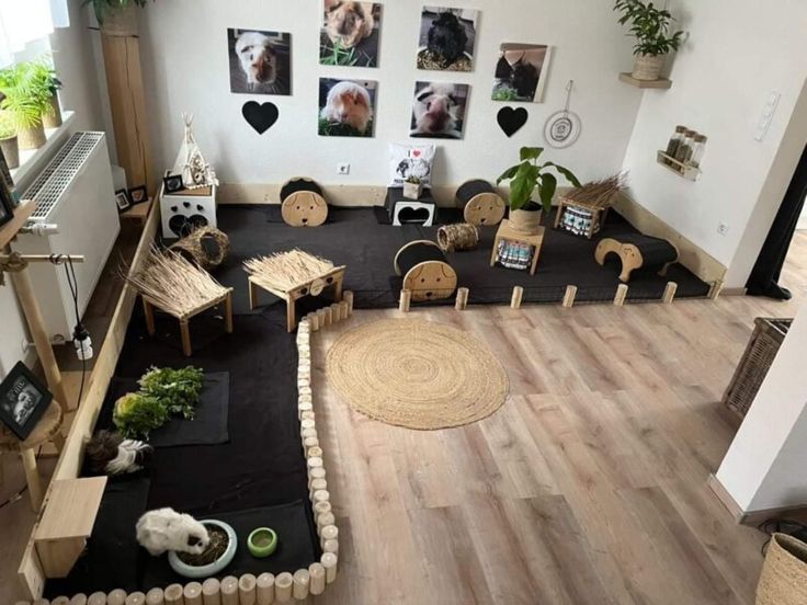 a living room filled with lots of furniture and plants on top of wooden flooring