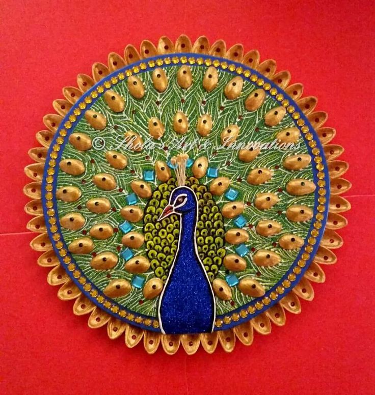 a peacock is shown on a red surface with gold dots and blue trim around it