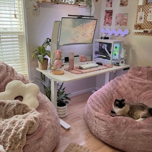 a cat laying in a dog bed on the floor next to a desk with a computer