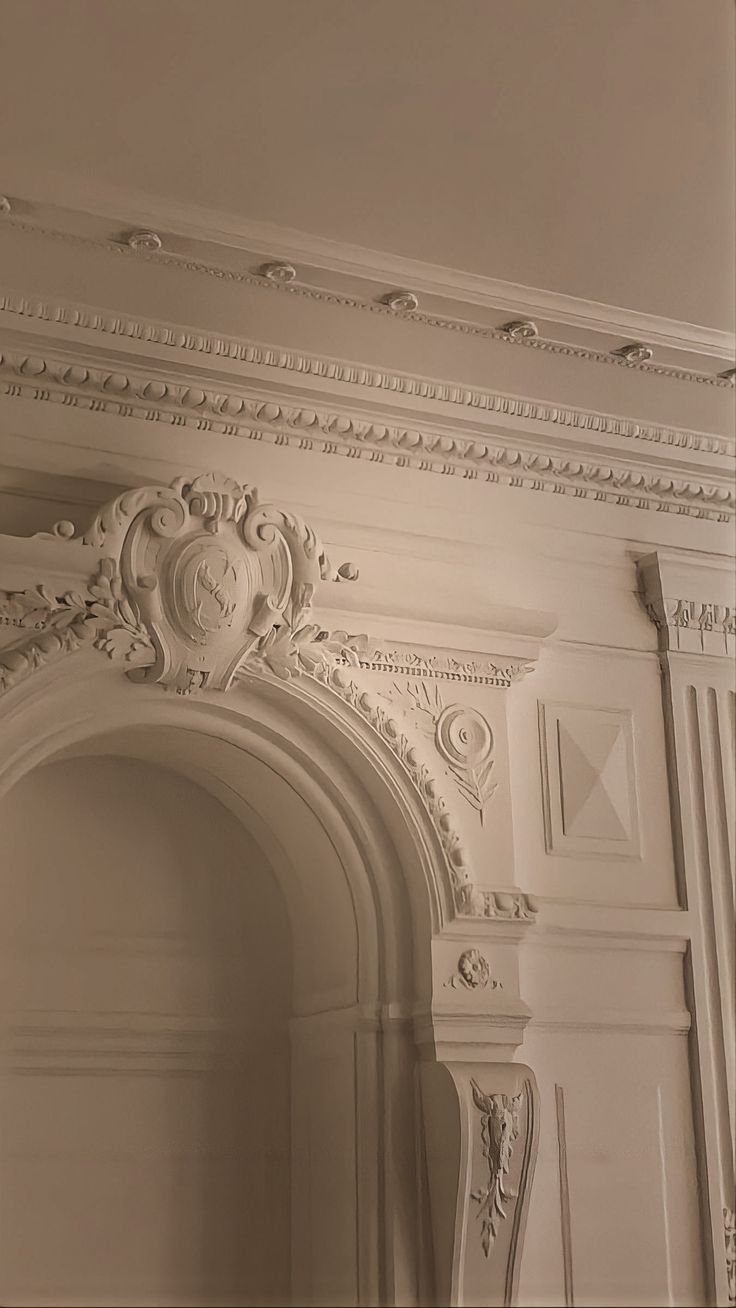 an ornate white fireplace surround in a room