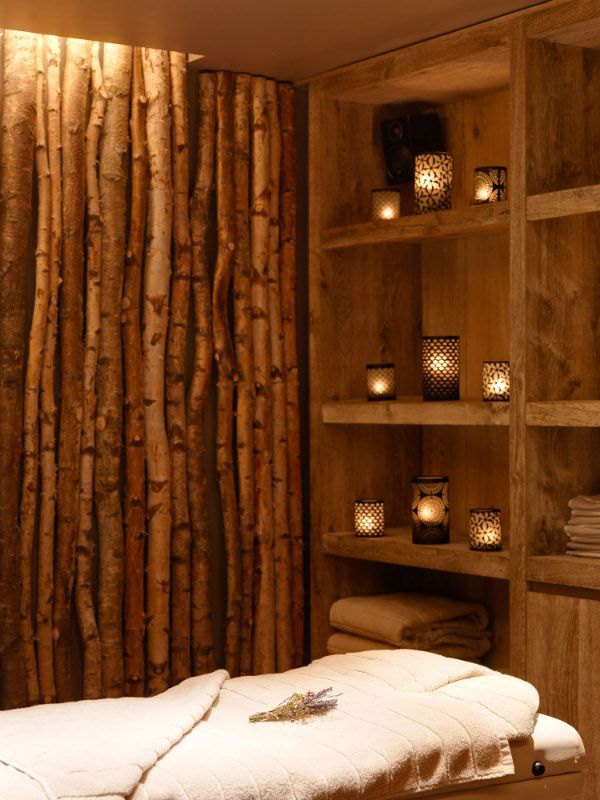 a spa room with wooden shelves and candles