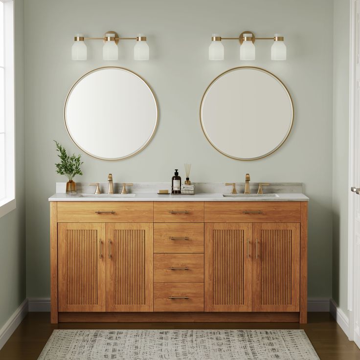 two round mirrors are above the double sink vanity