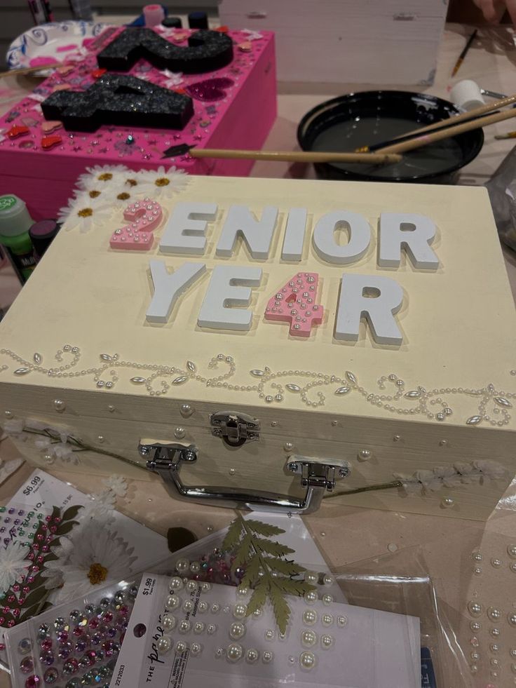 a white box with the words senior year written on it and other items surrounding it