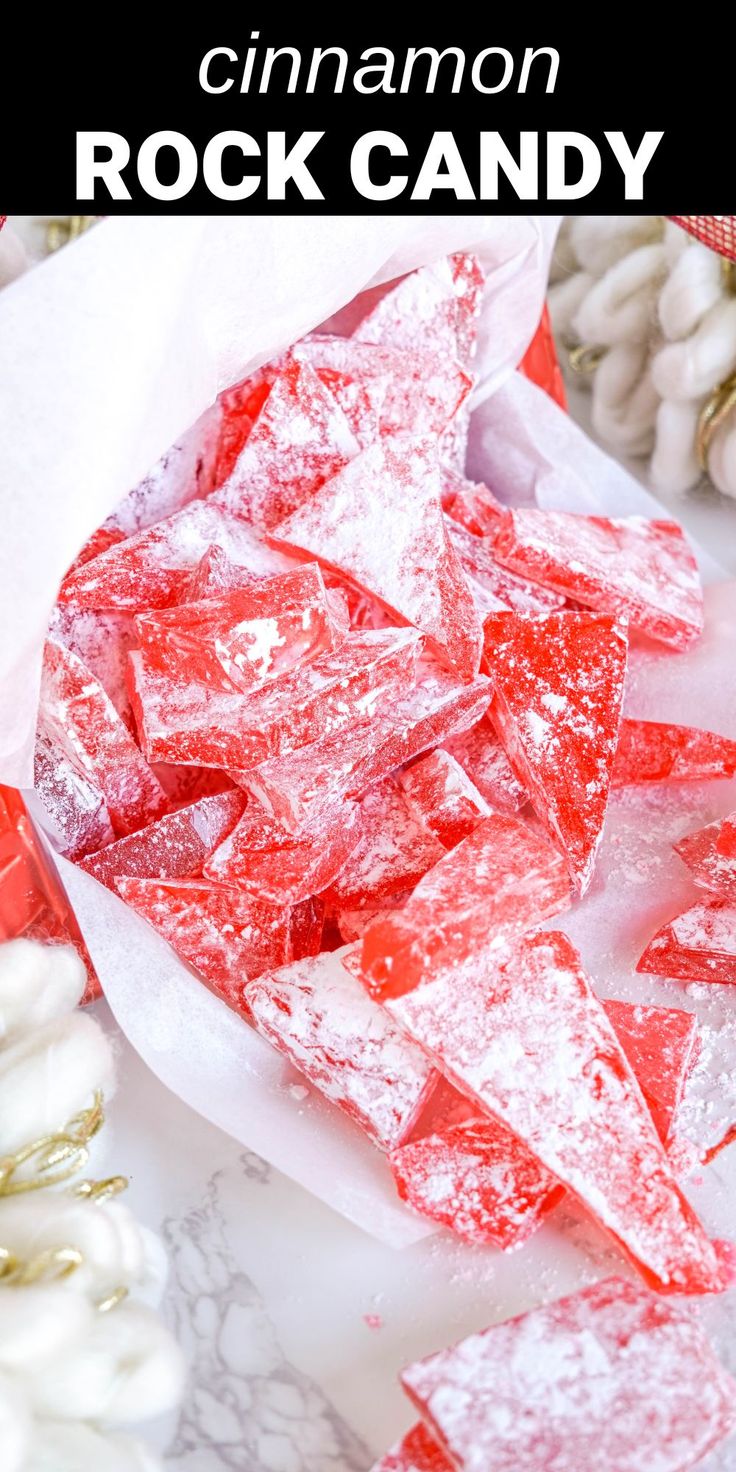 a pile of red rock candy sitting on top of a table