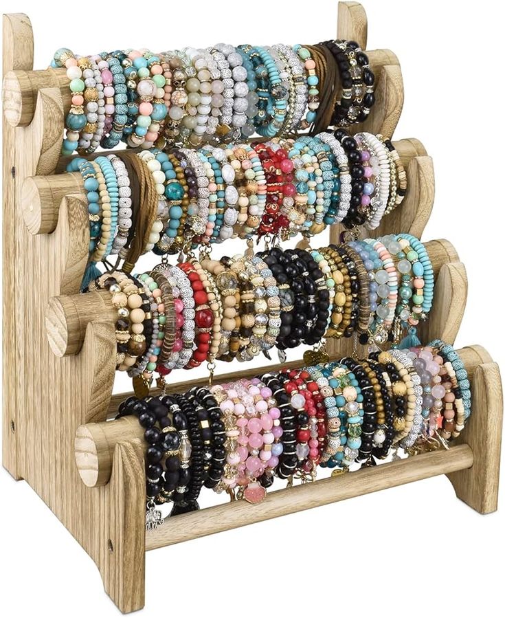 a wooden rack filled with bracelets on display