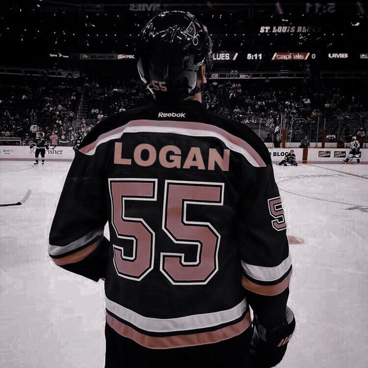 a hockey player standing on the ice in front of an empty arena during a game