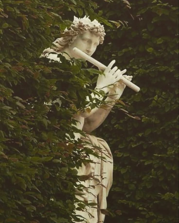 there is a statue in the bushes with a flute on its head and hands behind it