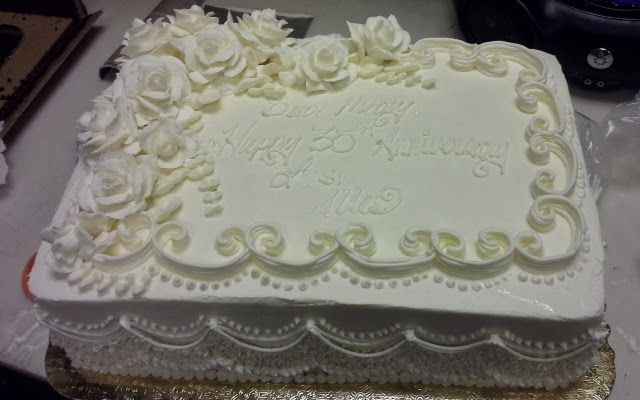 a large white cake sitting on top of a table