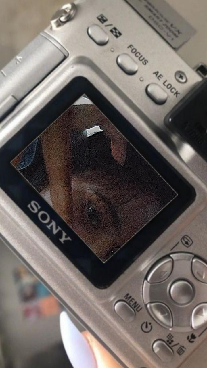 a close up of a person holding a camera with the image of a woman's face on it