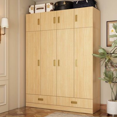 a large wooden cabinet in the corner of a room next to a potted plant