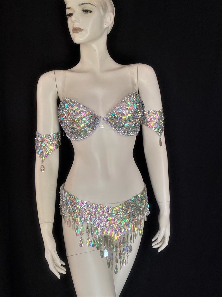 a white mannequin with silver and multicolored sequins on it