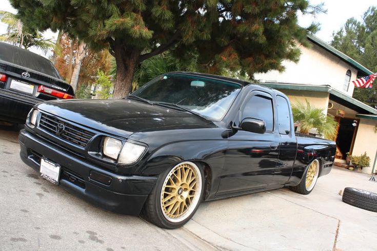 a black truck parked in front of a house