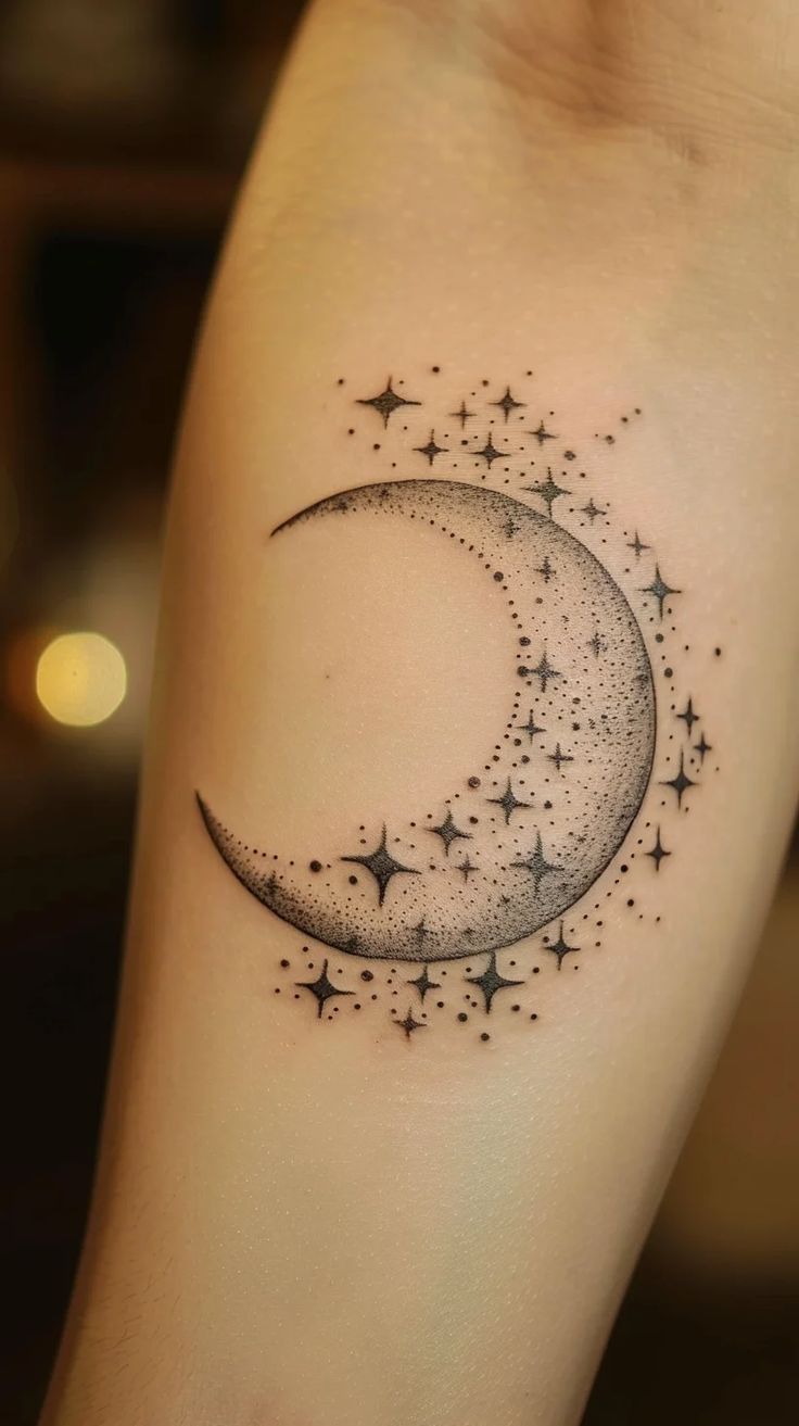 a crescent tattoo with stars on it