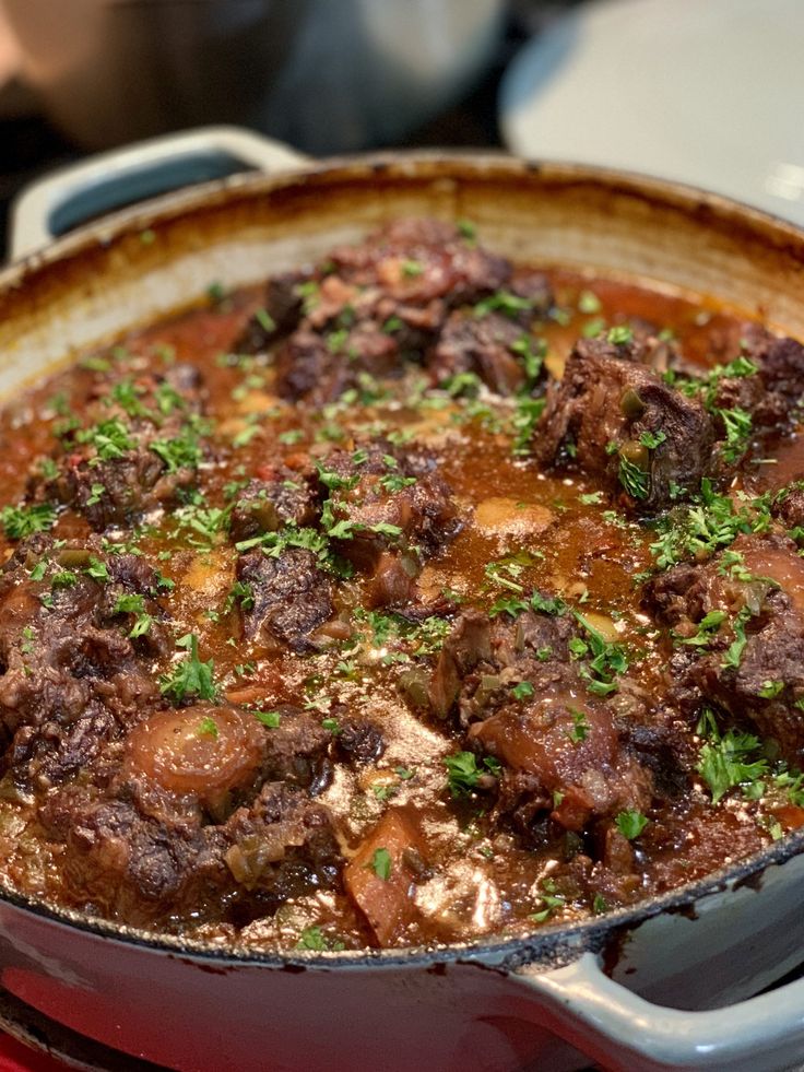 a pot filled with meat and vegetables on top of a stove