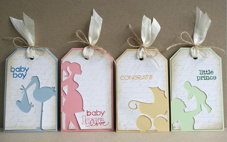 three tags with baby boy and girl silhouettes on them