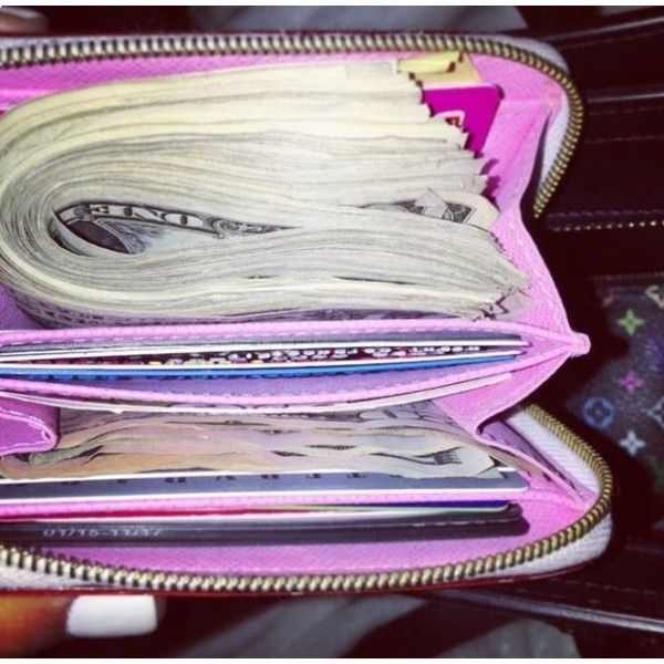 an open wallet with money sticking out of it's zippers and the inside is pink