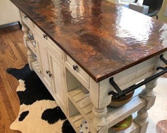 a kitchen island made out of an old cabinet and wood top with metal pulls on it