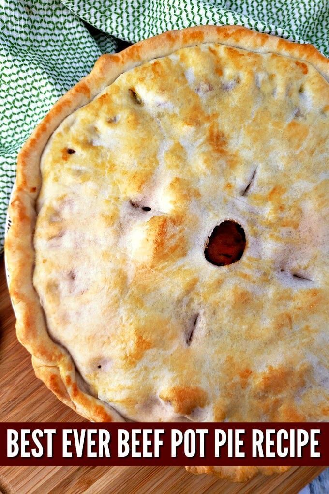 a pie sitting on top of a wooden cutting board with the words best ever beef pot pie