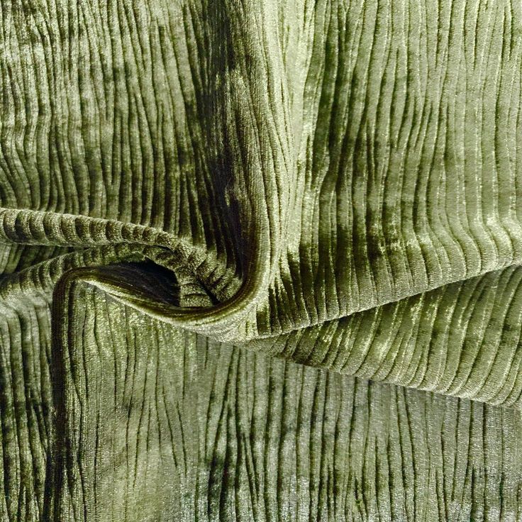 an up close view of green velvet fabric with wavy lines on the edges and sides