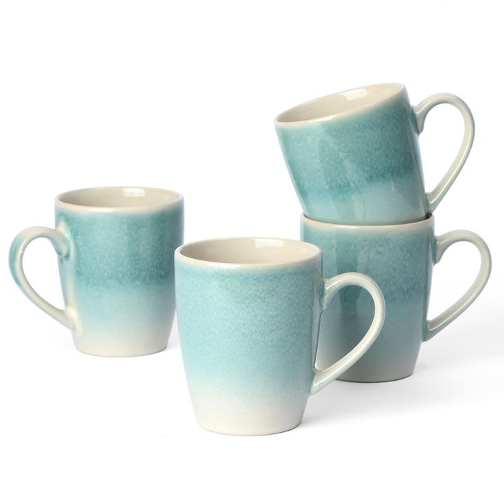 four coffee mugs are stacked on top of each other, one is blue and the other is white